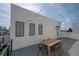 A rooftop deck, with outdoor seating, string lights, and a panoramic city view create a welcoming outdoor space at 1330 W Gray St # 1, Tampa, FL 33606