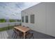 A modern rooftop deck provides a serene setting with stylish outdoor furniture and city views in the background at 1330 W Gray St # 1, Tampa, FL 33606