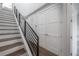 Elegant staircase with metal railing and hardwood steps, leading to the upper level at 1330 W Gray St # 1, Tampa, FL 33606