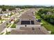 Aerial view of a residential neighborhood featuring a house with solar panels on the roof at 13686 Whiskey Daisy Dr, Dade City, FL 33525