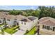 Aerial view of home featuring solar panels and a well manicured lawn at 13686 Whiskey Daisy Dr, Dade City, FL 33525