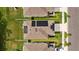 Bird's eye view reveals solar panels atop a house, set within a neighborhood of manicured lawns at 13686 Whiskey Daisy Dr, Dade City, FL 33525