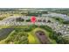 Aerial view of a Primary-planned community with ponds, green spaces, and well-maintained streets at 13686 Whiskey Daisy Dr, Dade City, FL 33525
