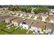 Aerial view of a neighborhood featuring homes with solar panels, green lawns, and fenced-in yards at 13686 Whiskey Daisy Dr, Dade City, FL 33525
