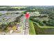 Drone shot showcases a neighborhood location pin surrounded by verdant greenery and a tranquil pond at 13686 Whiskey Daisy Dr, Dade City, FL 33525