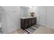 Modern bathroom featuring double sinks, dark wood cabinets, and stylish mirror at 13686 Whiskey Daisy Dr, Dade City, FL 33525