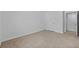 An empty bedroom featuring carpet, baseboards, and a window at 13686 Whiskey Daisy Dr, Dade City, FL 33525