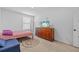 Cozy bedroom featuring neutral walls, carpet flooring, and a stylish area rug at 13686 Whiskey Daisy Dr, Dade City, FL 33525