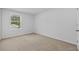A standard sized bedroom with carpet and one window at 13686 Whiskey Daisy Dr, Dade City, FL 33525