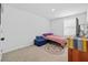 Bright bedroom featuring neutral walls, carpet flooring, and an area rug at 13686 Whiskey Daisy Dr, Dade City, FL 33525