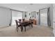 Cozy dining room featuring a wooden table with chairs, a bench and decorative accents at 13686 Whiskey Daisy Dr, Dade City, FL 33525