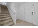 Entryway featuring tiled floor, staircase to the second floor, and coat closet at 13686 Whiskey Daisy Dr, Dade City, FL 33525