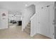 Bright foyer with tile flooring, a staircase, and an open view to the living area at 13686 Whiskey Daisy Dr, Dade City, FL 33525
