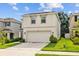 Charming two-story home with a two-car garage, manicured lawn, and welcoming curb appeal at 13686 Whiskey Daisy Dr, Dade City, FL 33525