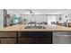 Open-concept kitchen island with a double sink and views into the living room and dining area at 13686 Whiskey Daisy Dr, Dade City, FL 33525