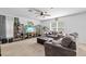 Spacious living room with comfortable seating, carpet flooring, and ample natural light at 13686 Whiskey Daisy Dr, Dade City, FL 33525