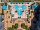Aerial view of the trefoil shaped pool surrounded by lounge chairs and manicured landscaping at 1520 Gulf Blvd # 1505, Clearwater Beach, FL 33767
