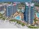 Stunning aerial view of luxury high-rise condos with beach access, pool, and tennis courts overlooking the ocean at 1520 Gulf Blvd # 1505, Clearwater Beach, FL 33767