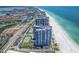 Aerial shot showcasing beachfront condos, tennis courts, and palm-lined streets near the pristine beach at 1520 Gulf Blvd # 1505, Clearwater Beach, FL 33767