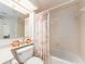 Full bathroom with tiled walls, seashell décor, and a bathtub at 1520 Gulf Blvd # 1505, Clearwater Beach, FL 33767
