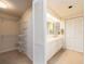 Walk-in closet and bathroom featuring a sink and ample cabinet space at 1520 Gulf Blvd # 1505, Clearwater Beach, FL 33767