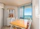 Bright dining area features a charming hutch, a wooden table, and picturesque ocean views at 1520 Gulf Blvd # 1505, Clearwater Beach, FL 33767