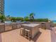 Modern outdoor grill area with grills, countertop and stools, perfect for hosting gatherings and enjoying outdoor dining at 1520 Gulf Blvd # 1505, Clearwater Beach, FL 33767
