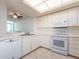 Well-lit kitchen features white cabinets, modern appliances, and tiled flooring at 1520 Gulf Blvd # 1505, Clearwater Beach, FL 33767