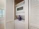A stacked washer and dryer inside of a closet with bi-fold doors that have horizontal slats at 1520 Gulf Blvd # 1505, Clearwater Beach, FL 33767