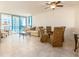 Bright and airy living and dining area with tile floors and floor-to-ceiling windows at 1520 Gulf Blvd # 1505, Clearwater Beach, FL 33767