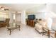 Bright living room featuring an accent mirror, comfy chair and television at 1520 Gulf Blvd # 1505, Clearwater Beach, FL 33767