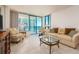 Bright living room featuring sliding glass doors with ocean views and comfortable seating at 1520 Gulf Blvd # 1505, Clearwater Beach, FL 33767