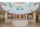 A rounded walkway overlooking the lobby with multiple entranceways with white pillars and tile floor at 1520 Gulf Blvd # 1505, Clearwater Beach, FL 33767
