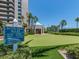 Manicured putting green beside high-rise building, offering residents a relaxing and convenient golfing experience at 1520 Gulf Blvd # 1505, Clearwater Beach, FL 33767