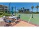 An outdoor tennis court offers a relaxing ambiance with shaded table and chairs at 1520 Gulf Blvd # 1505, Clearwater Beach, FL 33767