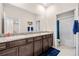 Bathroom with double vanity, granite counters, and separate door to a shower/bath combo at 1675 Bering Rd, Wesley Chapel, FL 33543