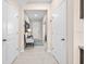 Hallway with neutral paint and tile floors with a small sitting area at 1675 Bering Rd, Wesley Chapel, FL 33543