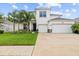 Well-manicured lawn leads up to this beautiful two-story home with a two car garage and well placed landscaping at 1675 Bering Rd, Wesley Chapel, FL 33543