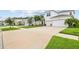 Inviting two-story home boasts a pristine white exterior, attached two-car garage, and a well-manicured lawn with ample parking space at 1675 Bering Rd, Wesley Chapel, FL 33543