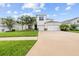 Two-story home with a well-manicured lawn and driveway leading to a two car garage at 1675 Bering Rd, Wesley Chapel, FL 33543