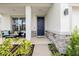 Covered front porch with an outdoor seating area and a blue front door at 1675 Bering Rd, Wesley Chapel, FL 33543