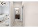 Hallway view showcasing a bedroom and bathroom, with neutral carpet and light walls at 1675 Bering Rd, Wesley Chapel, FL 33543