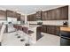 Gourmet kitchen with granite countertops, stainless steel appliances, and barstool seating at 1675 Bering Rd, Wesley Chapel, FL 33543