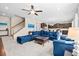Spacious living room with modern decor, fan, tile floors, and staircase access at 1675 Bering Rd, Wesley Chapel, FL 33543