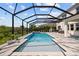 Sparkling pool and spa surrounded by a screened enclosure and spacious patio at 1675 Bering Rd, Wesley Chapel, FL 33543