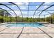 Inviting screened-in pool and spa area with a large patio at 1675 Bering Rd, Wesley Chapel, FL 33543