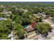 Aerial view of home showcasing lush landscaping, a private pool, and a well-maintained neighborhood at 1683 Pine St, Largo, FL 33774