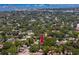 An aerial view of a quaint home, surrounded by lush green landscape, a bay and buildings in the distance at 1683 Pine St, Largo, FL 33774