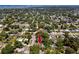 An aerial view of a quaint home with swimming pool surrounded by lush green landscape near the water at 1683 Pine St, Largo, FL 33774