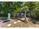Charming backyard with a decorative trellis, statuary and mature shade trees at 1683 Pine St, Largo, FL 33774